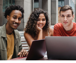 Smiling students working on laptops