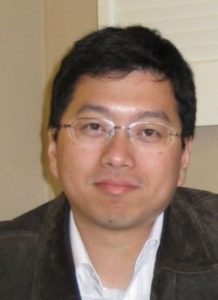 Man with glasses smiling