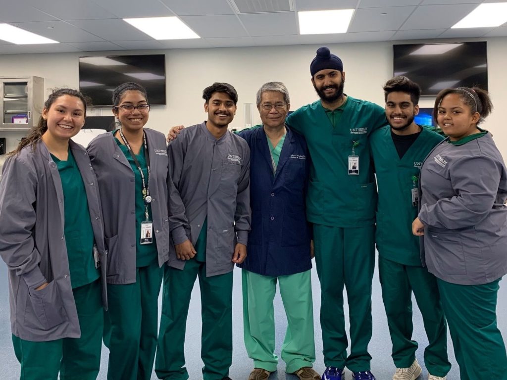 Armando Rosales poses with students