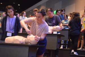a student practicing narcan administration on a simulation dummy