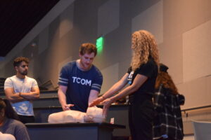 Bobbie Bratton with student demonstrating narcan on a simulation dummy