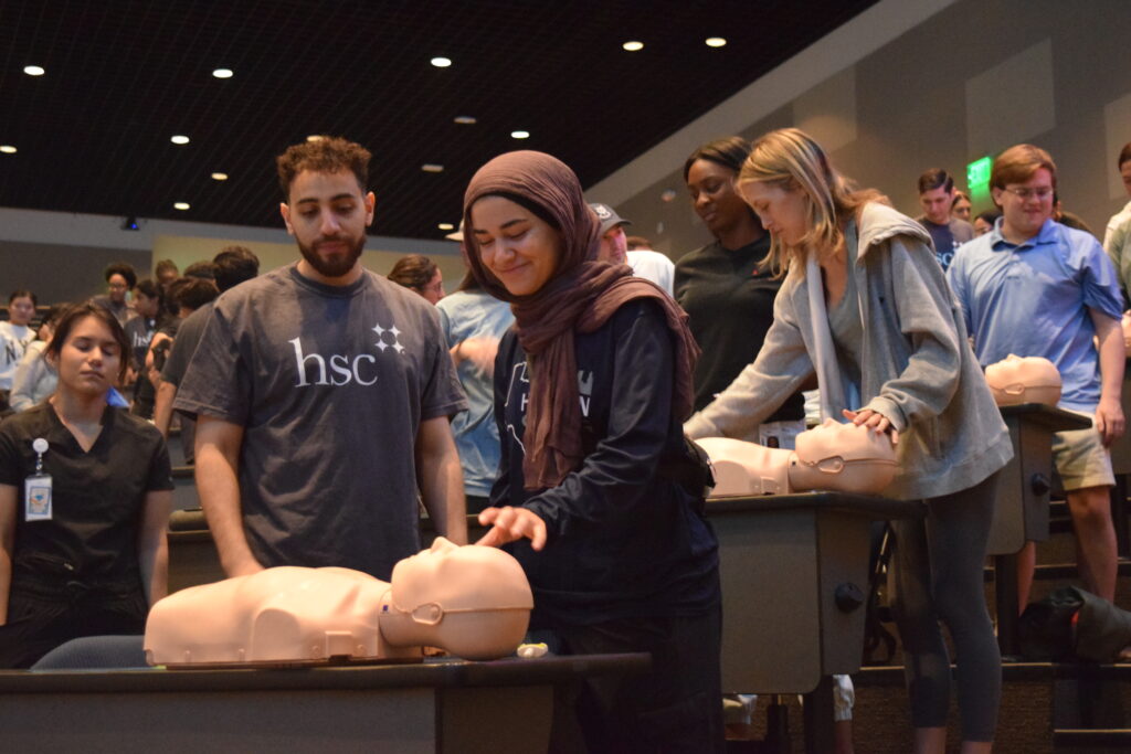 students working with a simulation dummy