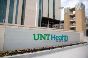 Artist representation of how the new UNT Health logo would look in full color on a campus sign
