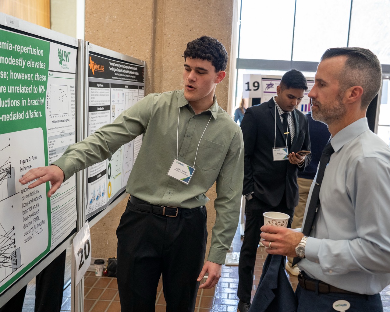Student presentes research while dean looks on