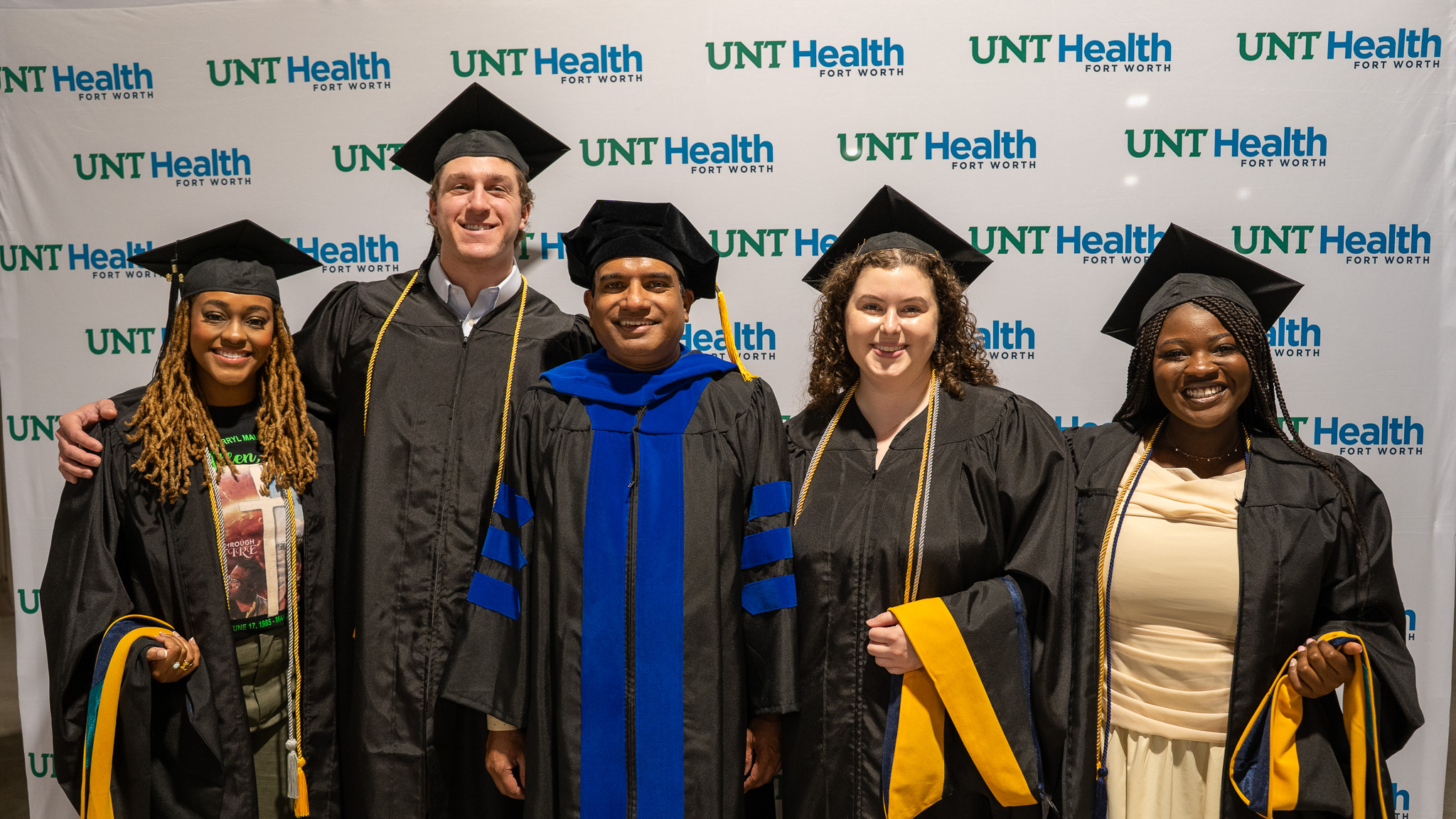 Five CRM graduates in their regalia