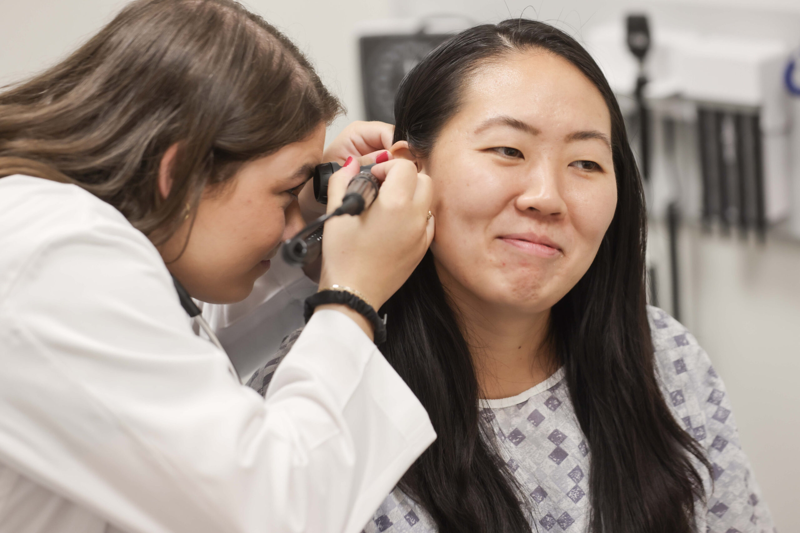 A PA student examining an ear