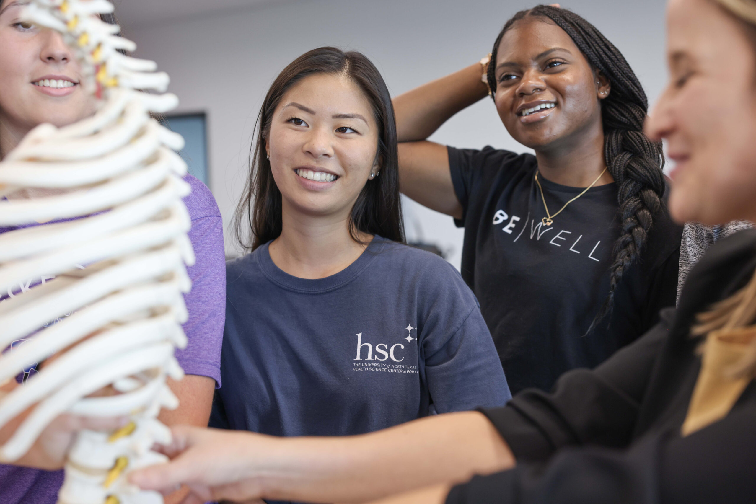 Students watching their professor teach using a skeleton