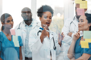 Nurses and doctors have a discussion during a brainstorming session.