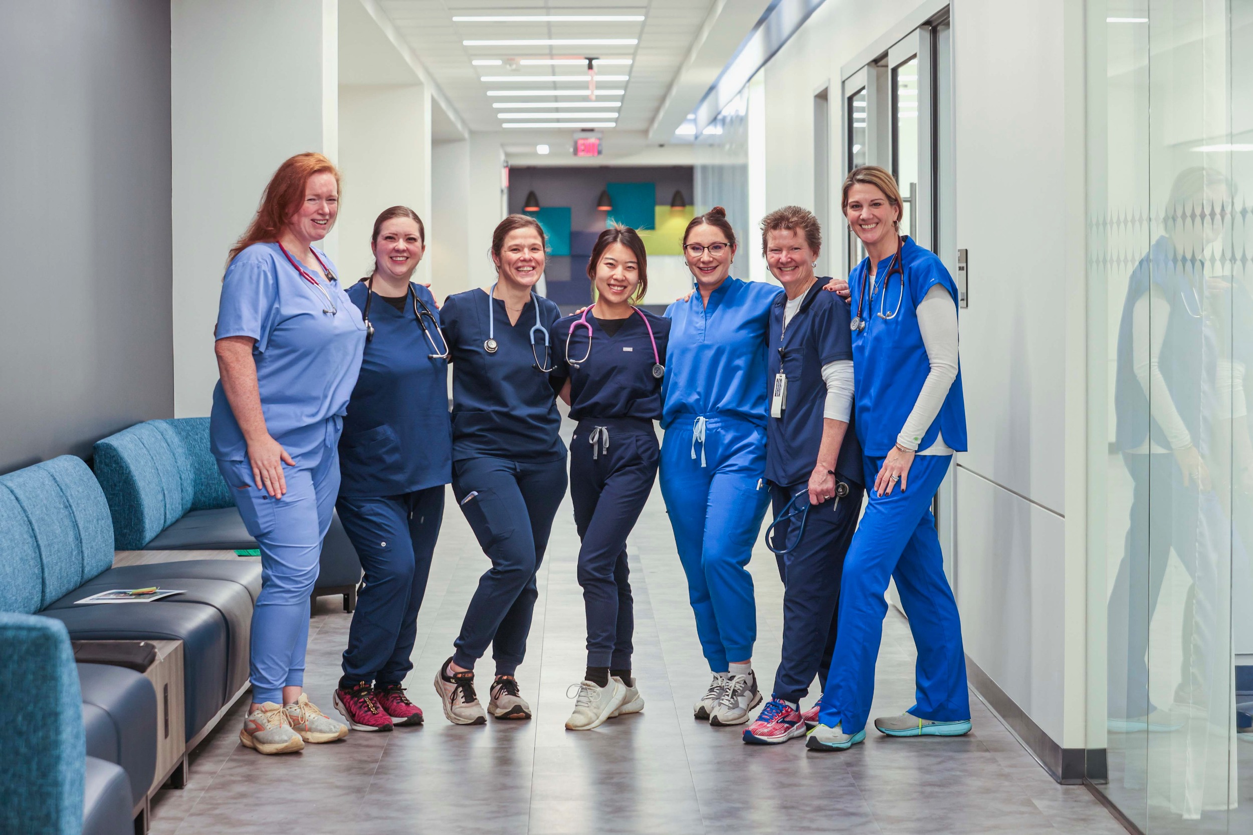 group of nursing students and instructors standing the hallway for a group photo