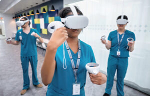 Three students use virtual reality tools during a lesson.