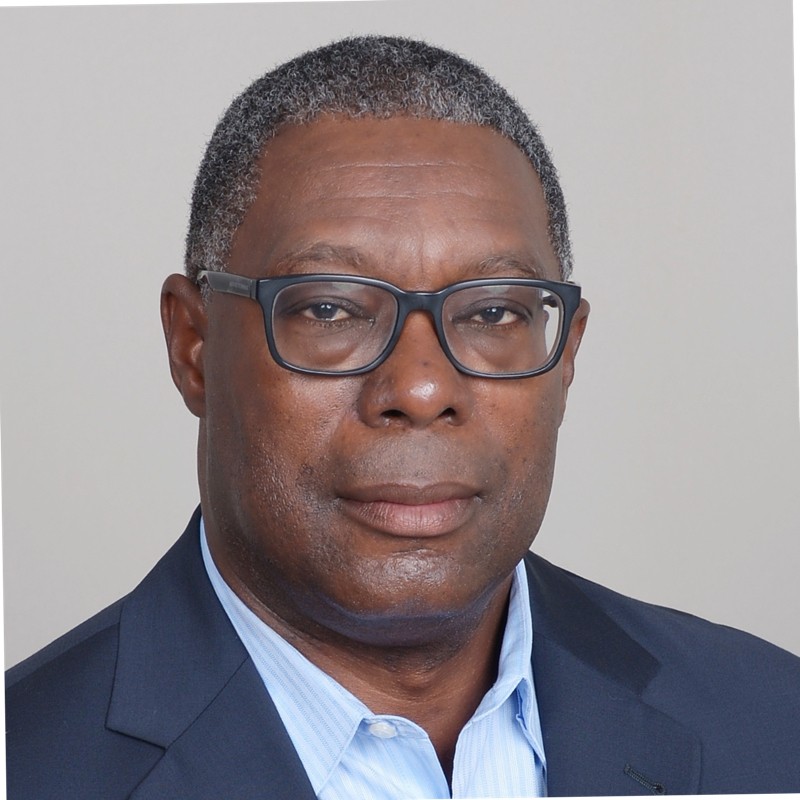 Kemp Louis headshot wearing a navy blue suit
