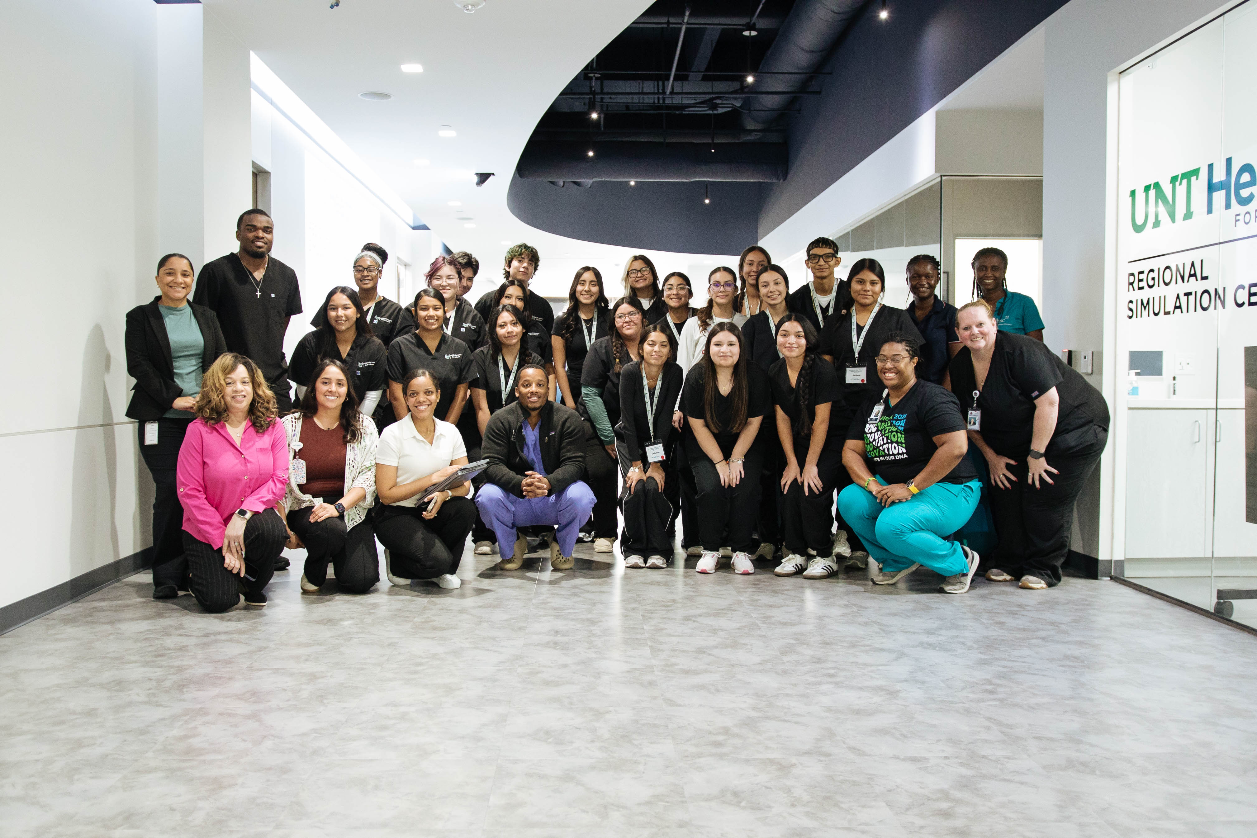 Group of students posing for a photo in the simulation center
