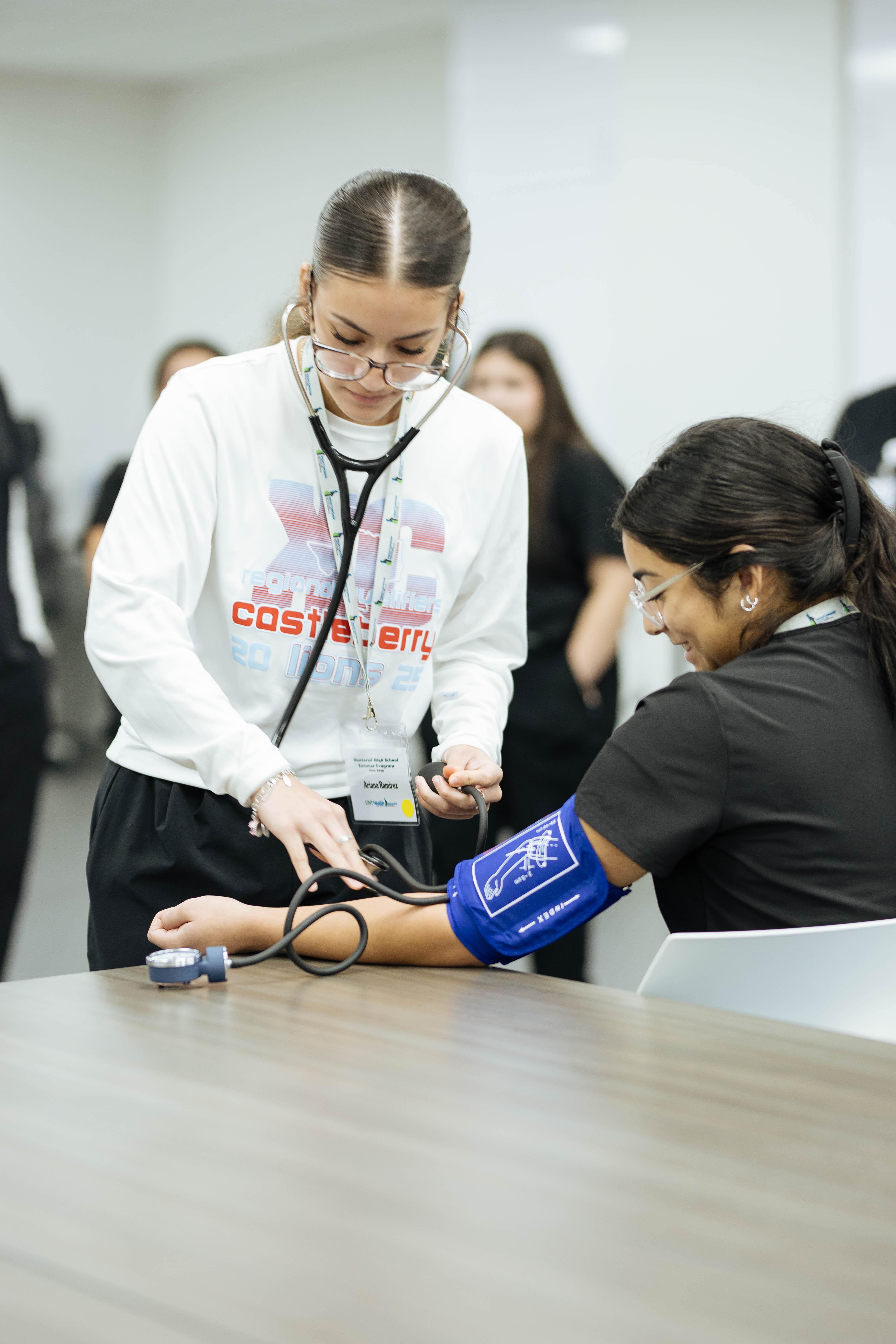 student checking the blood pressure of another student