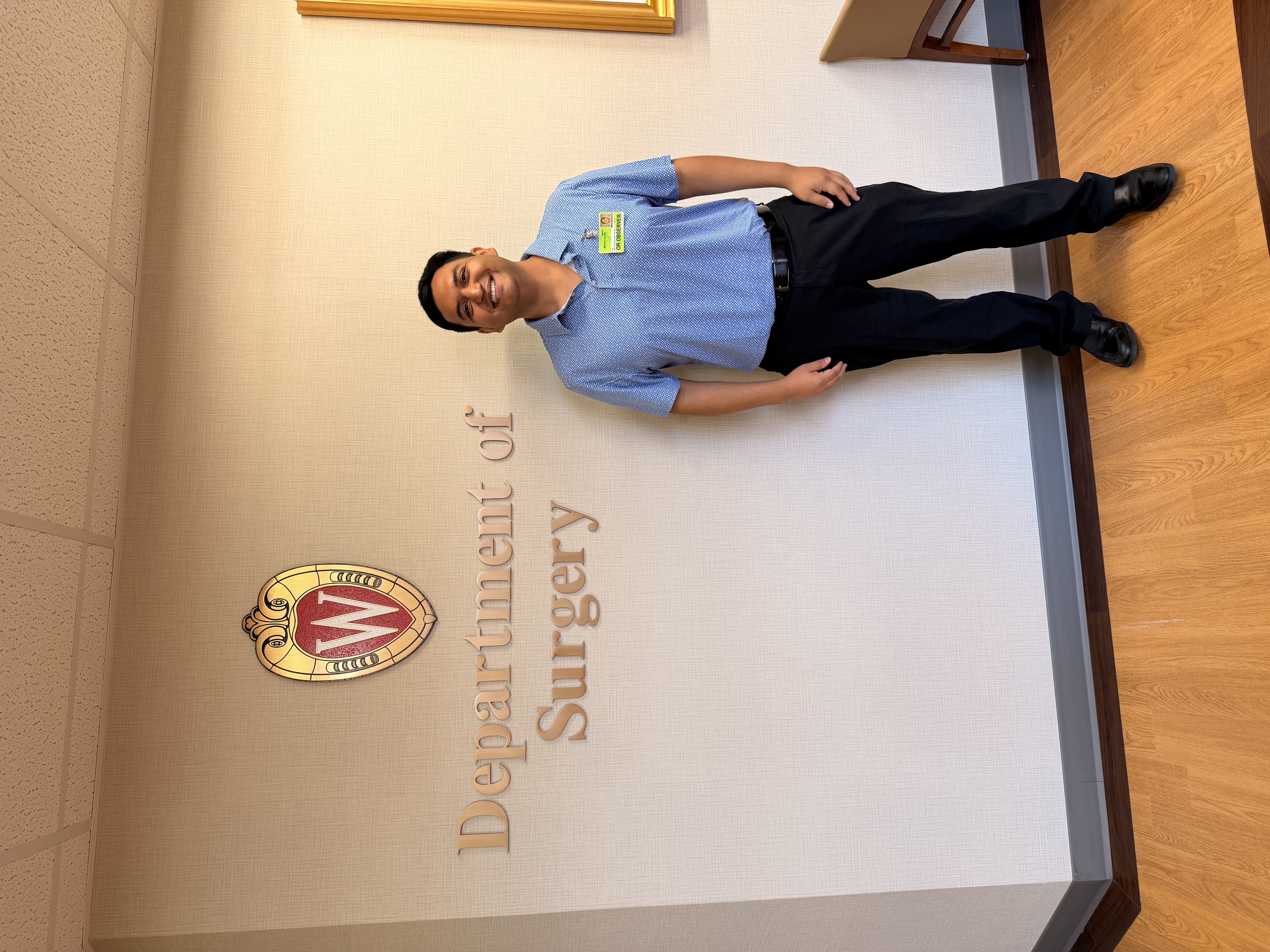 Correa smiles in front of a surgery department sign