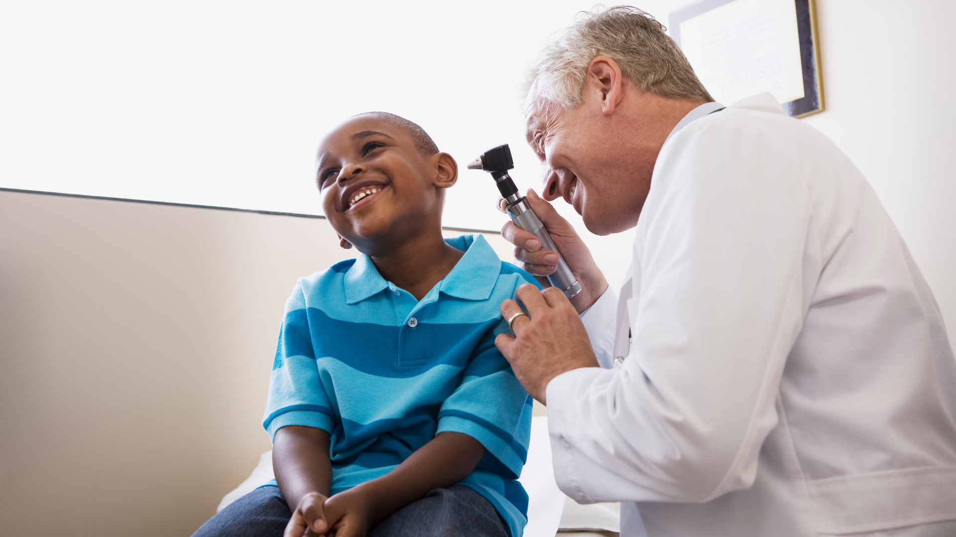 Provider looking in a pediatric patient's ear