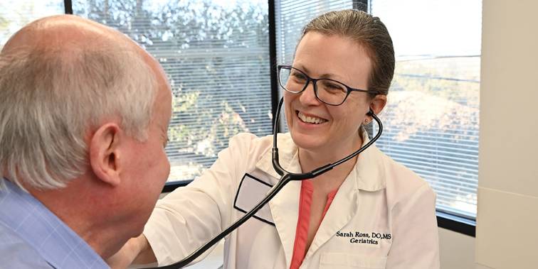 Dr. Sarah Ross listening to a patient's heart