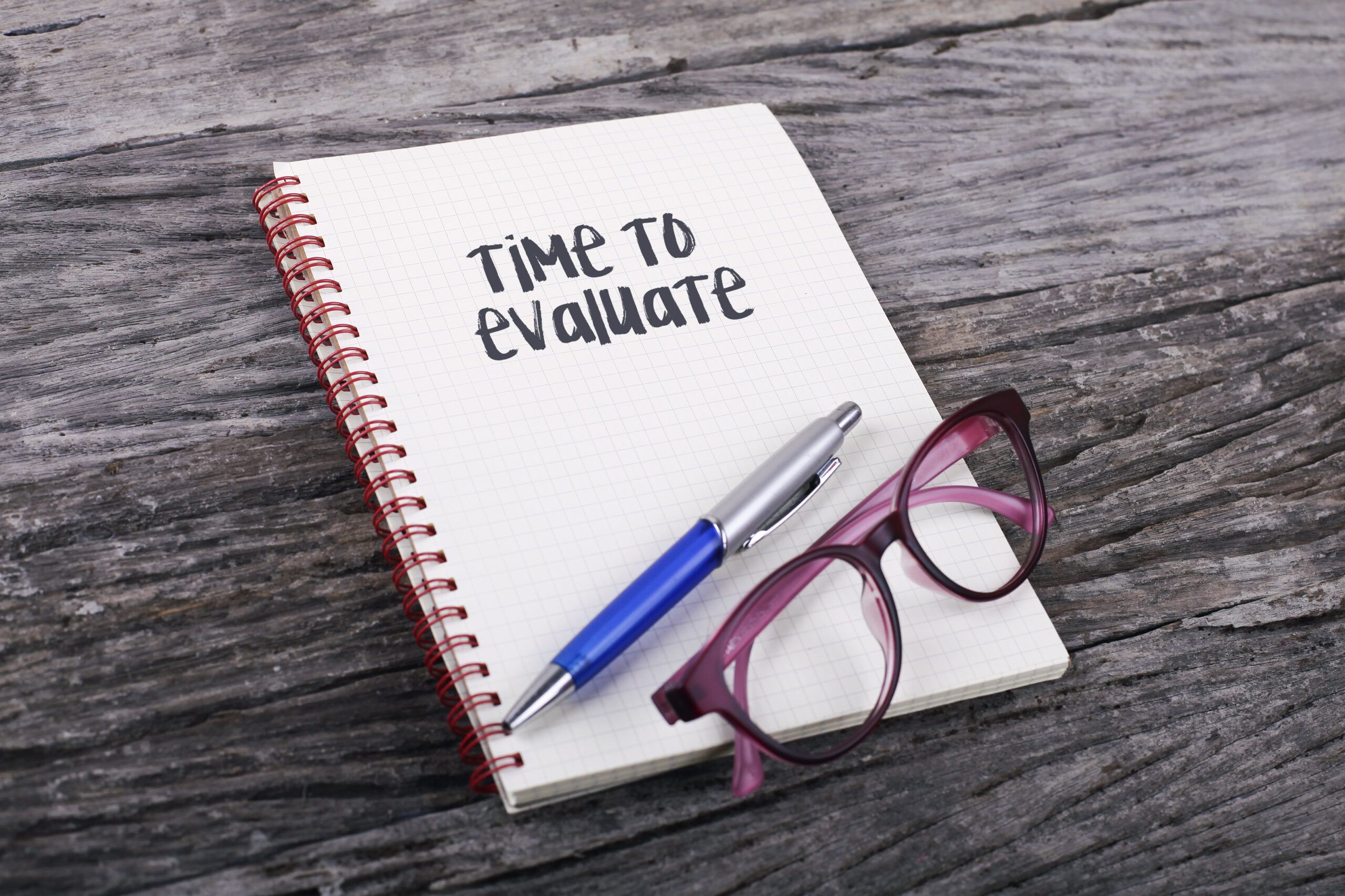 Notebook open to show page on which it is written "Time to evaluate"