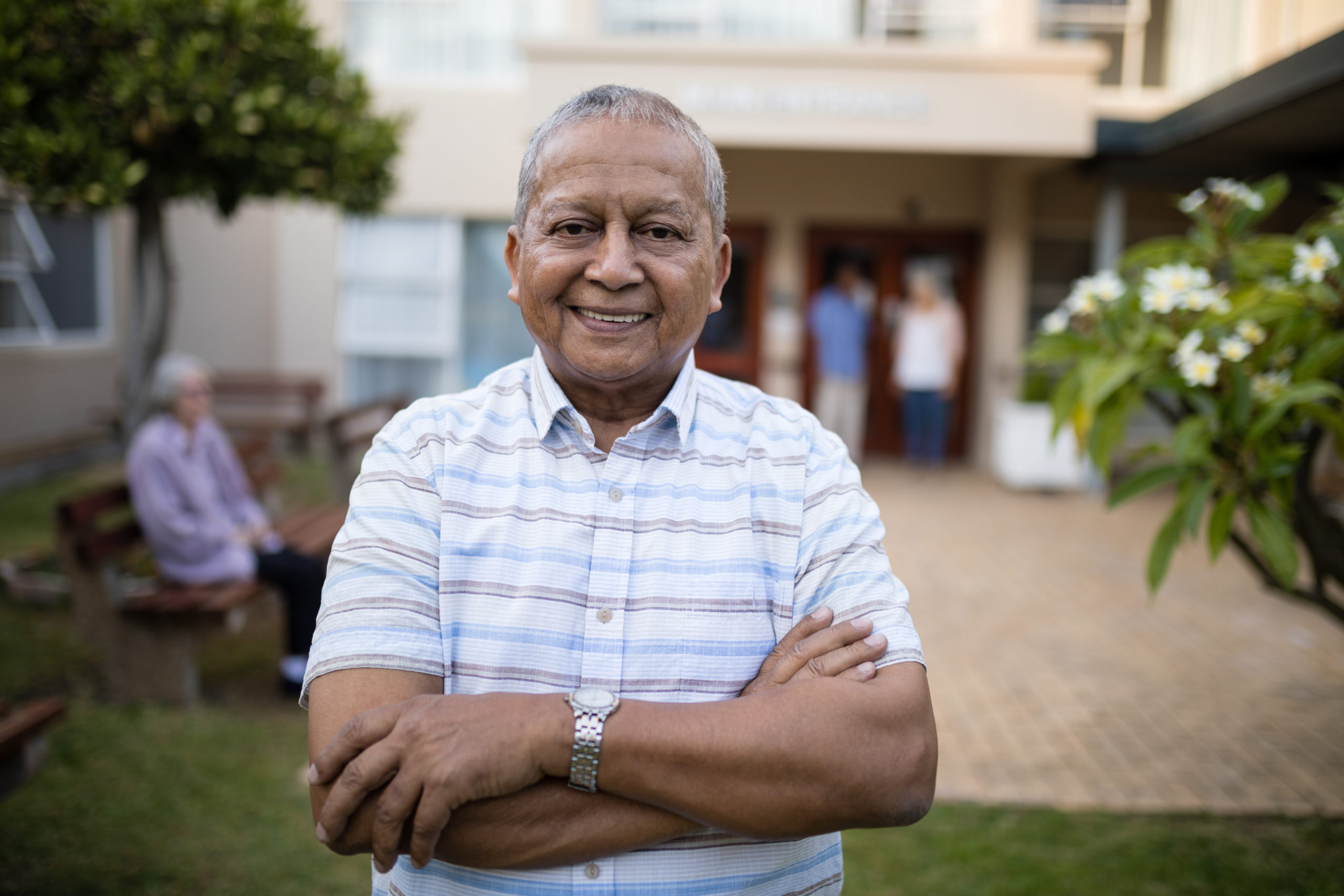 Man smiling with his arms crossed in front of him