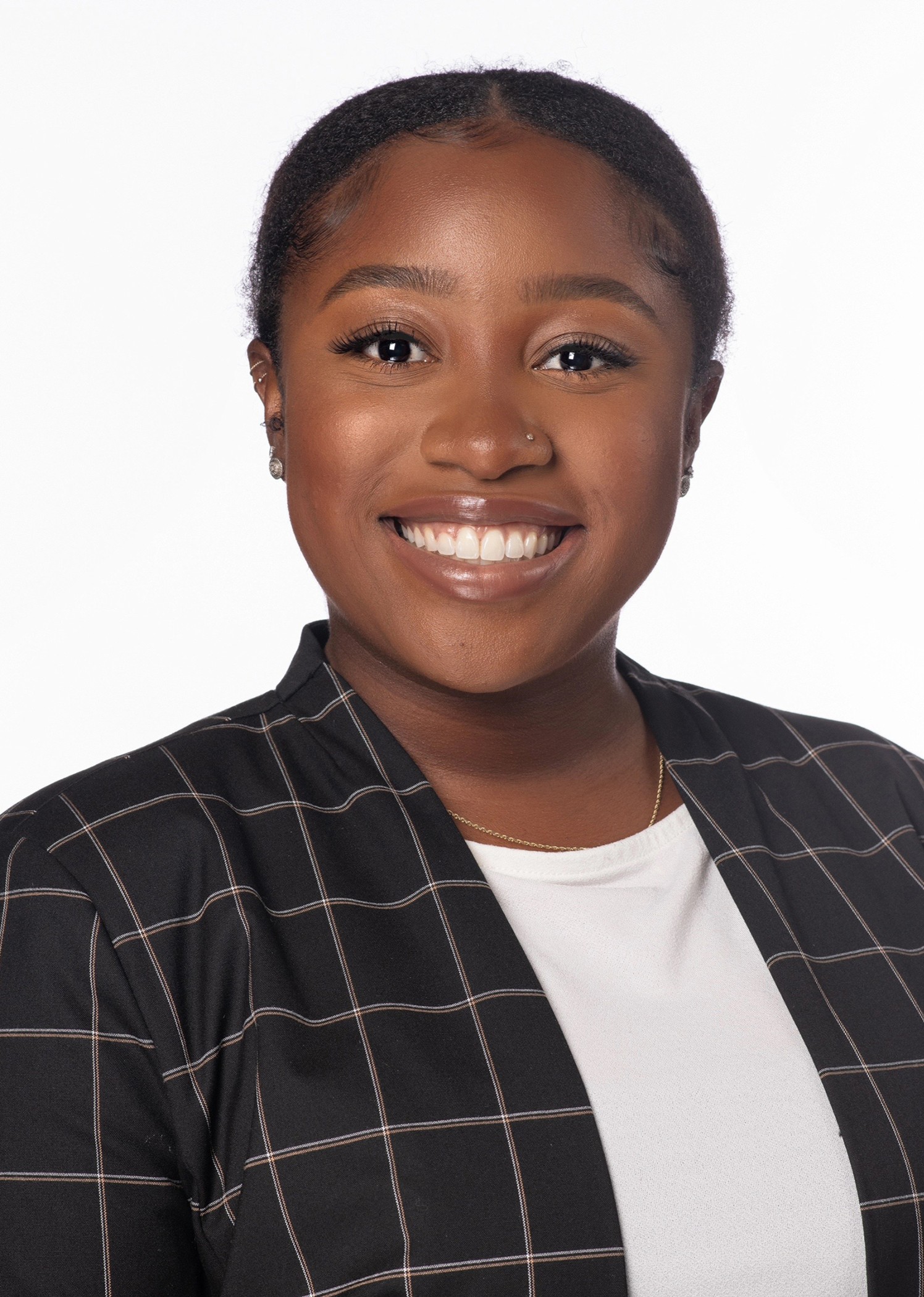 Maya McMillian headshot wearing a black windowpane blazer