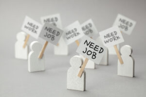 Need Job. Crowd Of Unemployed People With Posters On Gray Backgr